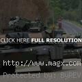 Military Tanks Riding on Civilia...